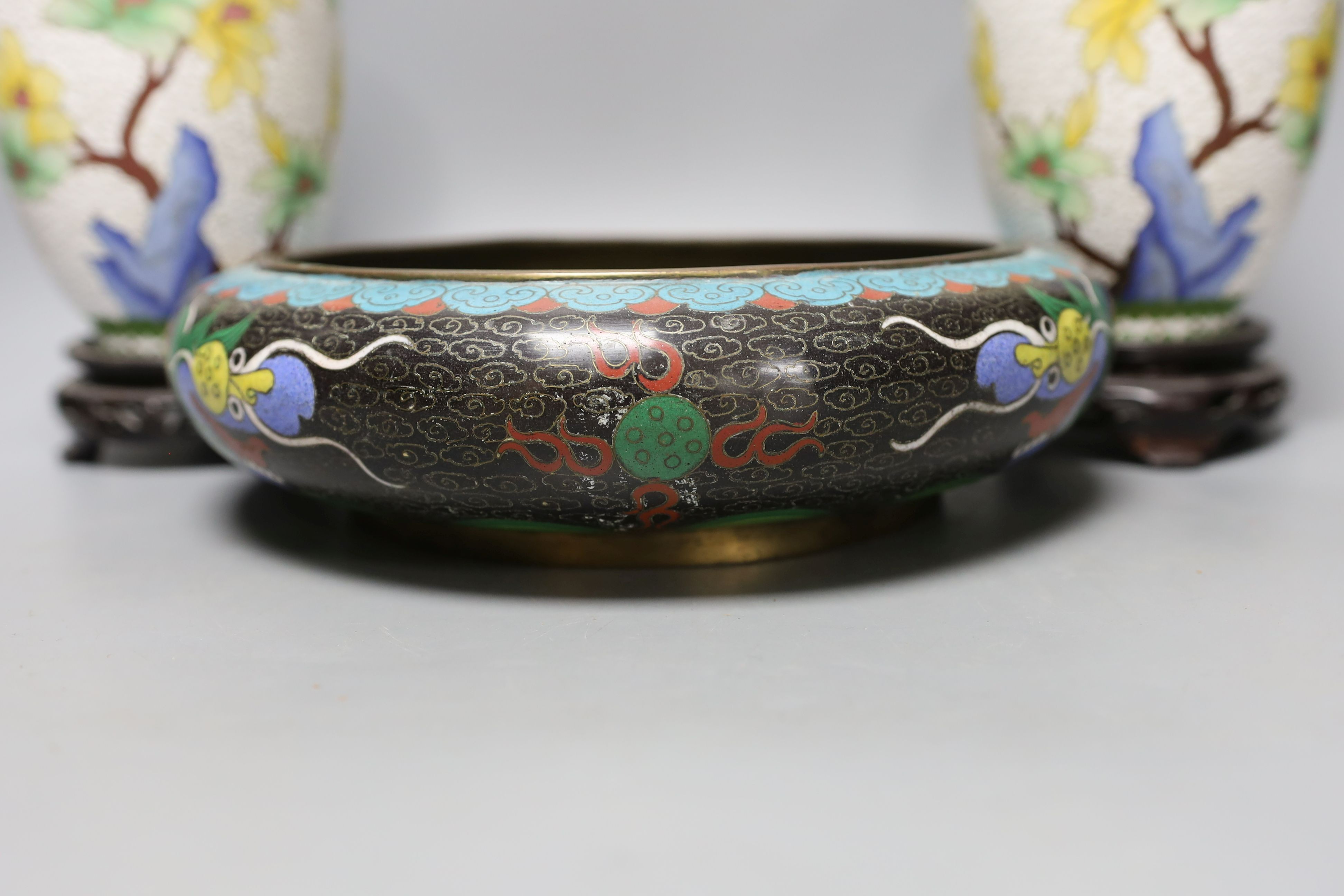 A pair of Chinese cloisonné enamel vases, 25cm tall including stands, together with a Chinese cloisonné enamel dragon bowl (3)